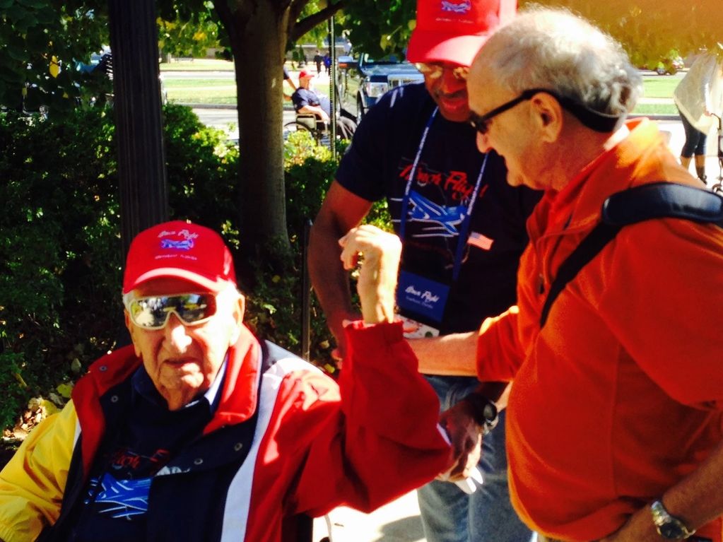 Captain Morris Pruchansky with his on and a group of his fellow veterans