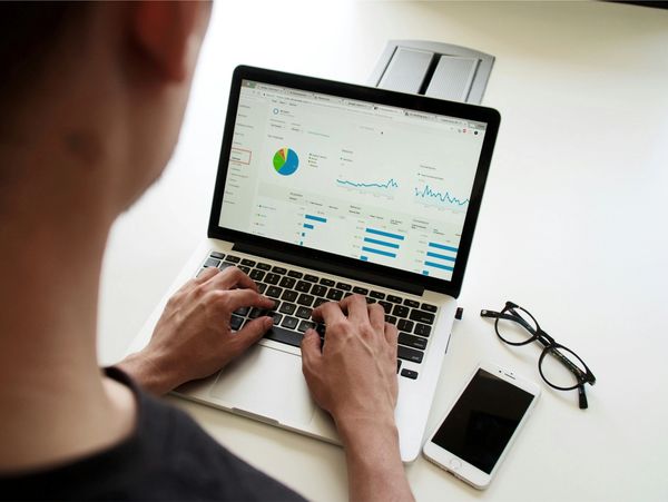 Man typing on laptop with many charts
Photo by Campaign Creators on Unsplash