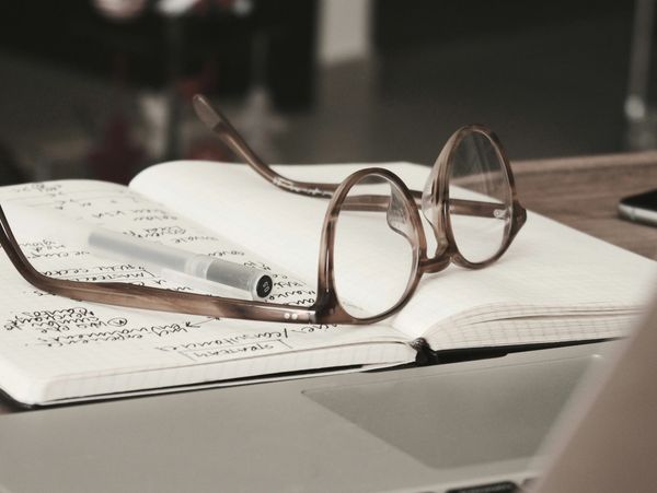 A pair of glasses on an open notebook
Photo by Mark Fletcher-Brown on Unsplash
