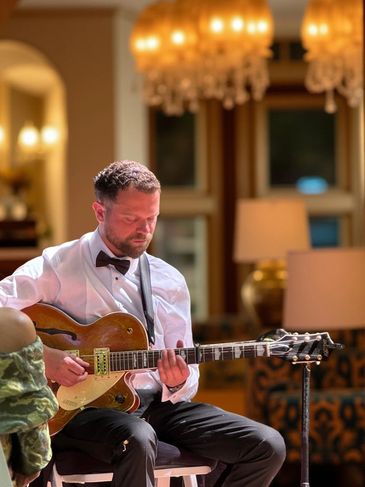 Charlie Hodgson performing live acoustic guitar set at private event in Buckinghamshire, wedding