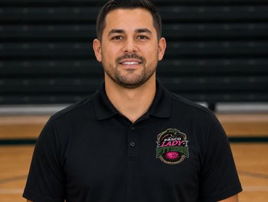 Man in a black polo shirt with a sports logo.