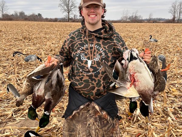 Owner of Elvers Creek Outdoors wearing an Elvers Creek Outdoors sweatshirt with six mallard ducks. 