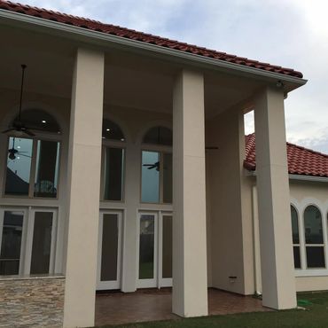 Two story home with dark window tint 