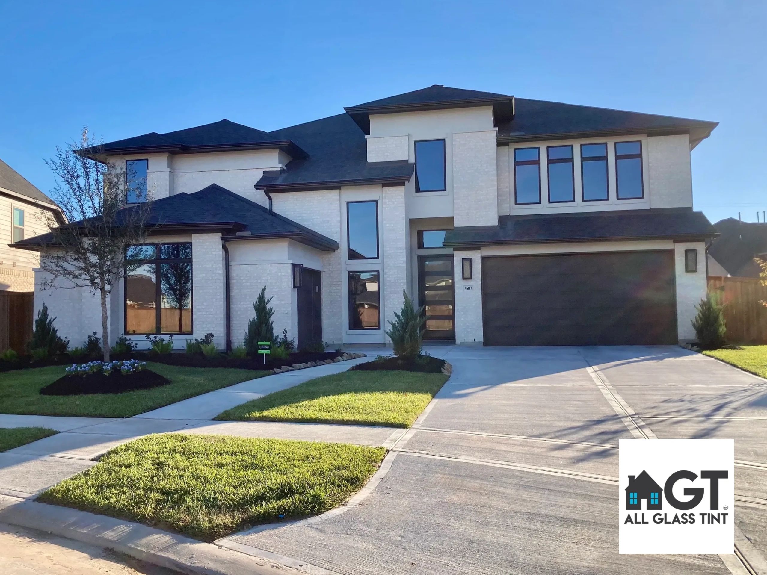 Two story home with dark tinted windows