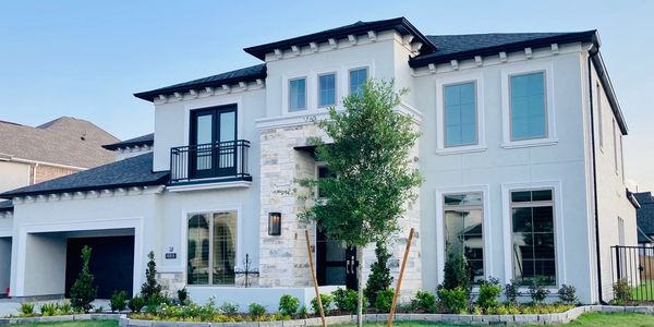 White two story home with tinted windows