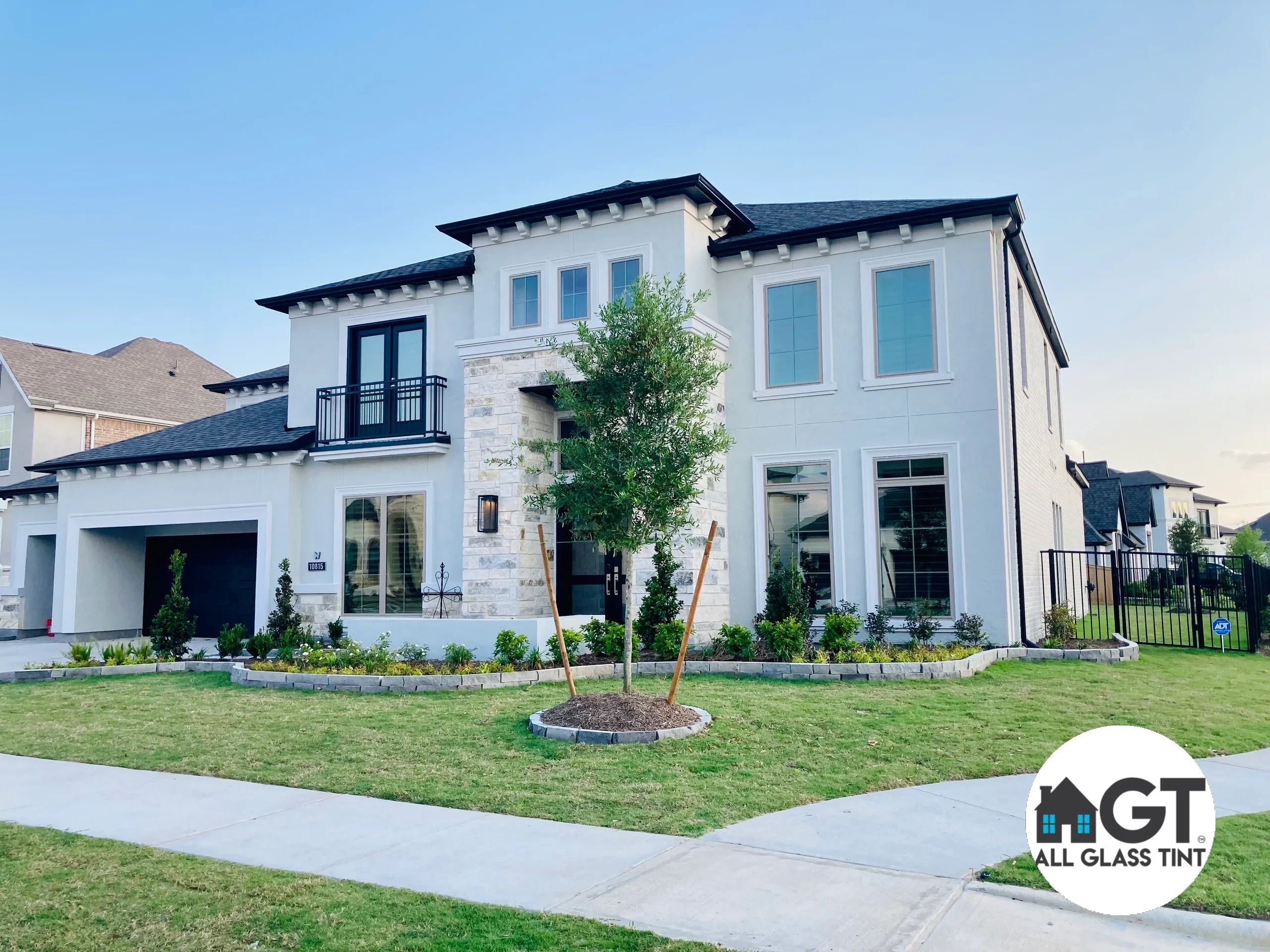Two story home with reflective tinted windows