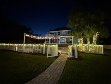 House decorated with string lights at night.