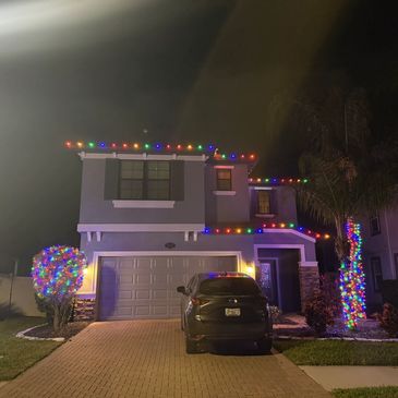 Multi Color roofline, loli pop bushes, palm tree and hedge lighting in Long Lake Ranch. 