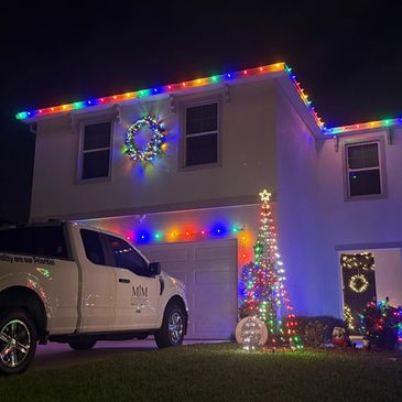 Multi Color roofline, bush, tree, garage and wreath lighting.