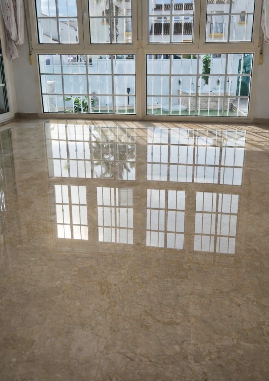 Sunlight reflecting off a polished marble floor through large windows.