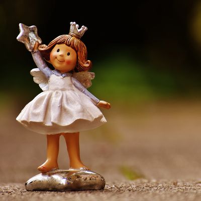 A cute fairy figurine with a crown and star wand.