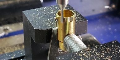 An Ace Tubular key being cut in a machine.