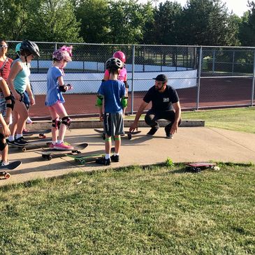 Outdoor group skateboarding lesson for Girl Scouts being lead by SK8 Chicago’s Ben Karbin.
