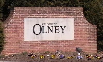 A picture of a installed sign that says  welcome to Olney 