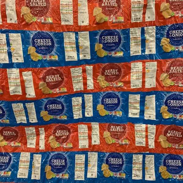 Rows of crumpled crisps packets in Ready Salted and Cheese &amp; Onion flavors.