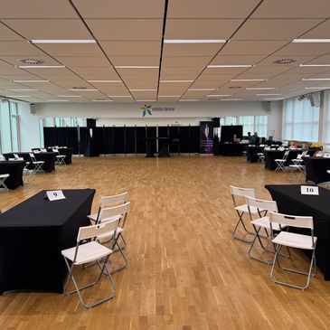 Empty conference room with tables and chairs.
