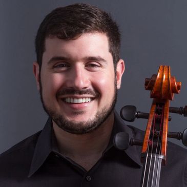 Smiling man with a cello against a gray background.