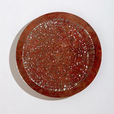 Calligraphic laser-cut metal relief sculpture by Khalil Chishtee, depicting a shield.