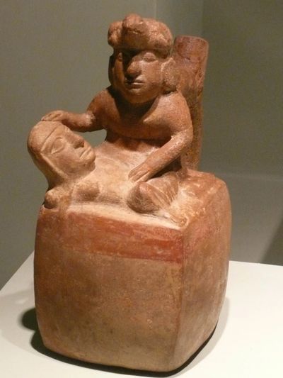Ancient pot depicting a healer healing a person on a platform.