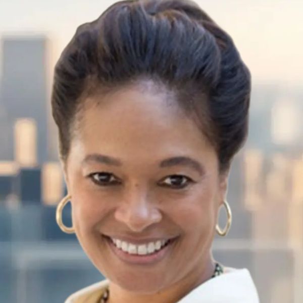 Smiling woman with hoop earrings and styled hair.