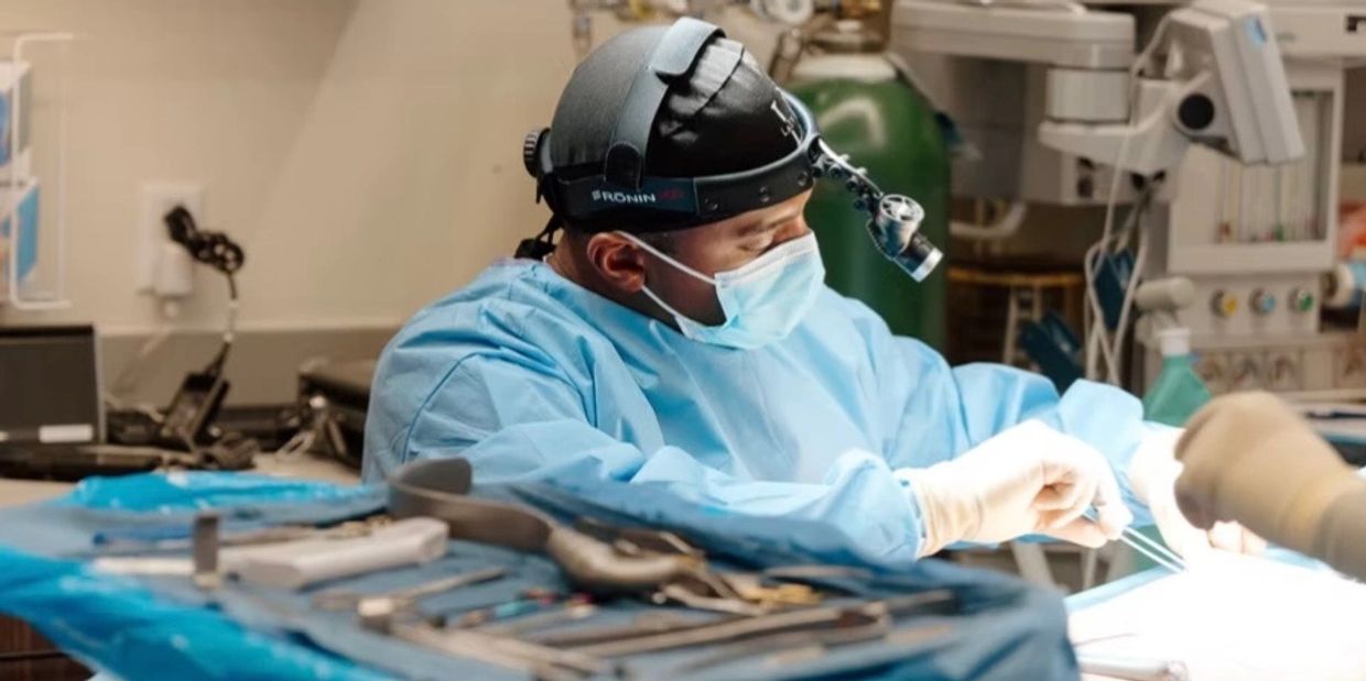 Surgeon performing an operation in a sterile operating room.