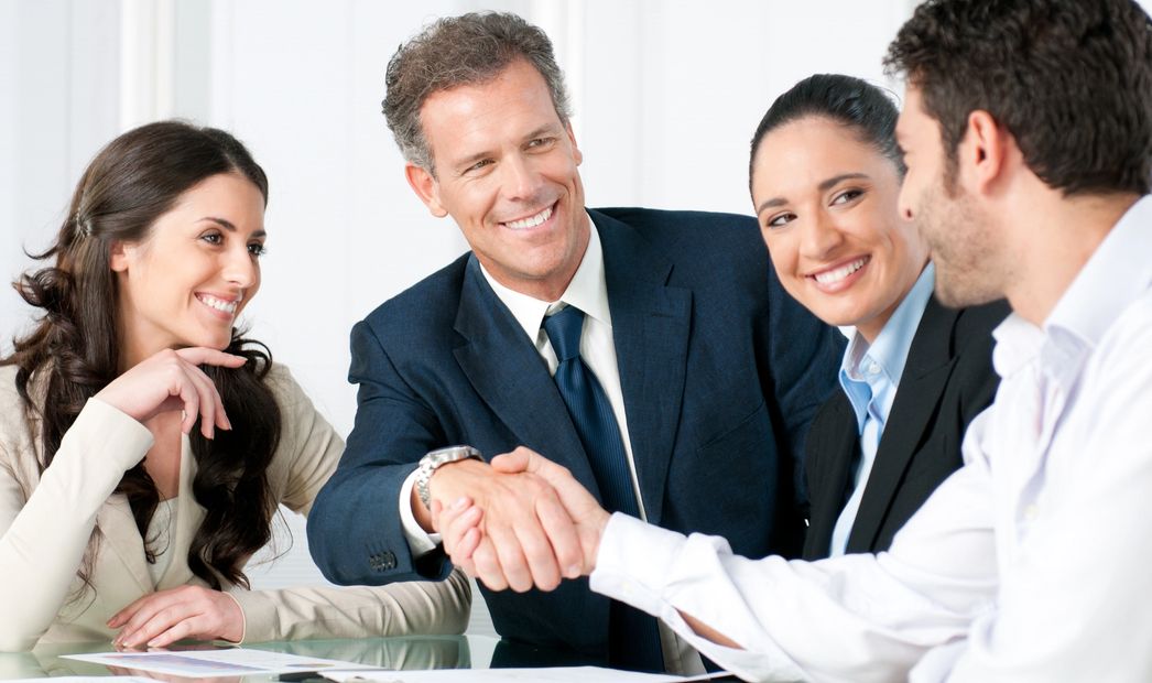 Personal injury attorneys and medical-legal consultants shaking hands over a claim