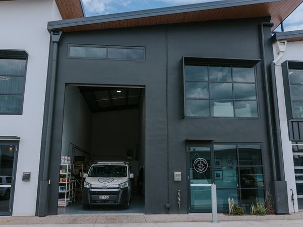 Coffee Brigade HQ with the roller door open and the van parked inside