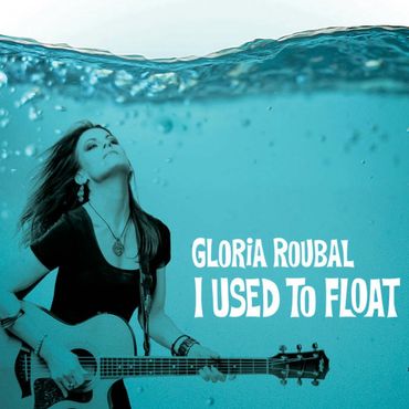 Gloria Roubal playing guitar underwater, album titled 'I Used to Float'.