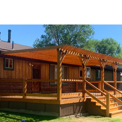 Wooden deck with pergola attached to a house on a sunny day.