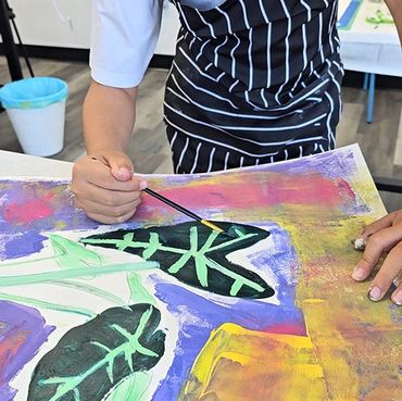 Person painting colorful butterfly wings.