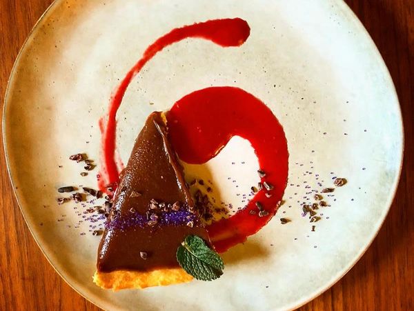Dark Chocolate Sea-salted Caramel Tart with a Raspberry Coulis 