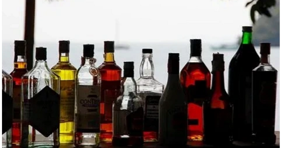 Multiple sized and colored bottles of alcoholic beverages