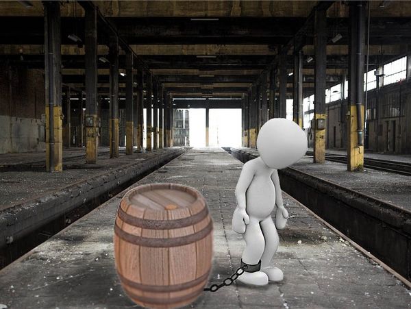 Person chained to whiskey barrel