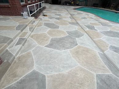 Pool deck with a stone like concrete coating. 