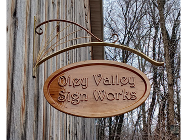 Custom brass sign hanger and cherry wood sign.