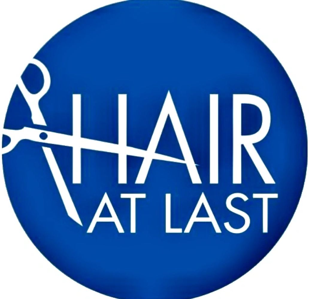 Hair at Last Logo, that reads Hair at last with scissors through it.