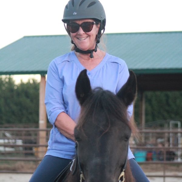 Beth Gaston our organization founder sitting on a horse