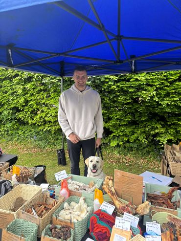 A man went to dog treat shop with his dog