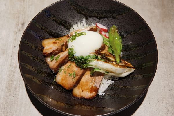 Braised pork belly bowl with a soft porched egg.