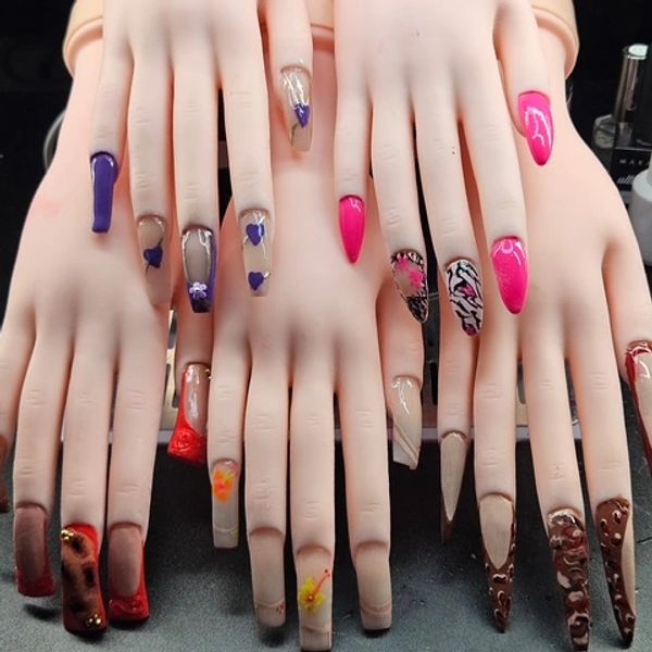 Mannequin hands displaying various colorful and artistic nail designs.