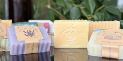 Assortment of colorful handcrafted soaps with labels.