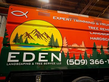Orange, green, and yellow wrap on a chip truck for Eden Landscaping
