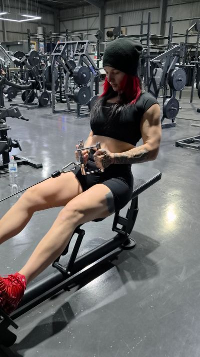 Woman with muscular build working out at the gym.