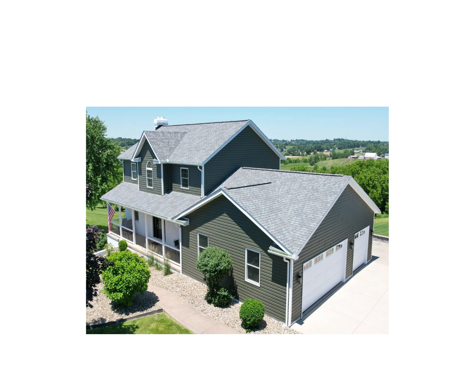 Two-story suburban house with gray siding and a double garage.