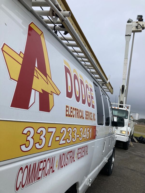 A. Dodge Electric team on a job repairing parking lot lights with the bucket truck