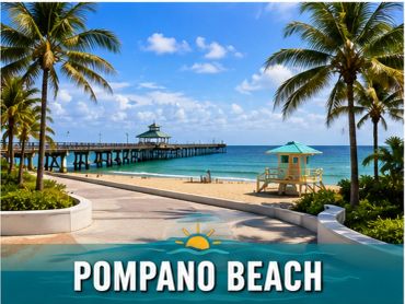 Sunny day at Pompano Beach with palm trees and pier.