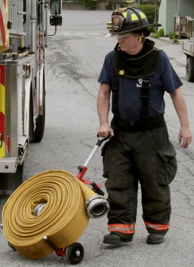 a man carrying pipe for fire extinguish