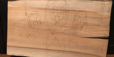 An initial simple sketch is put on the wood