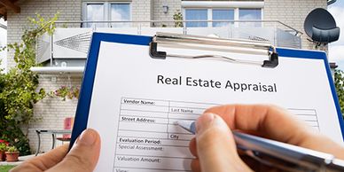 A person filling out a real estate appraisal form outside a house.