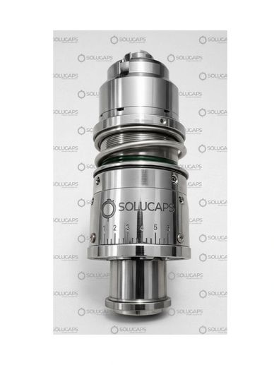 Precision metal component with measurement scale labeled SOLUCAPS.